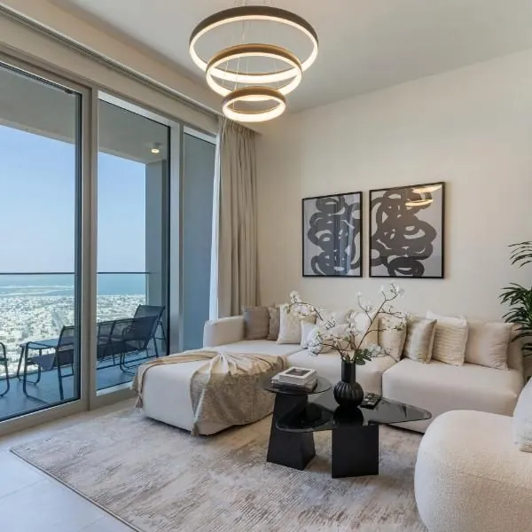 Apartment interior design in Dubai with a bright living area, soft tones, and balcony view.