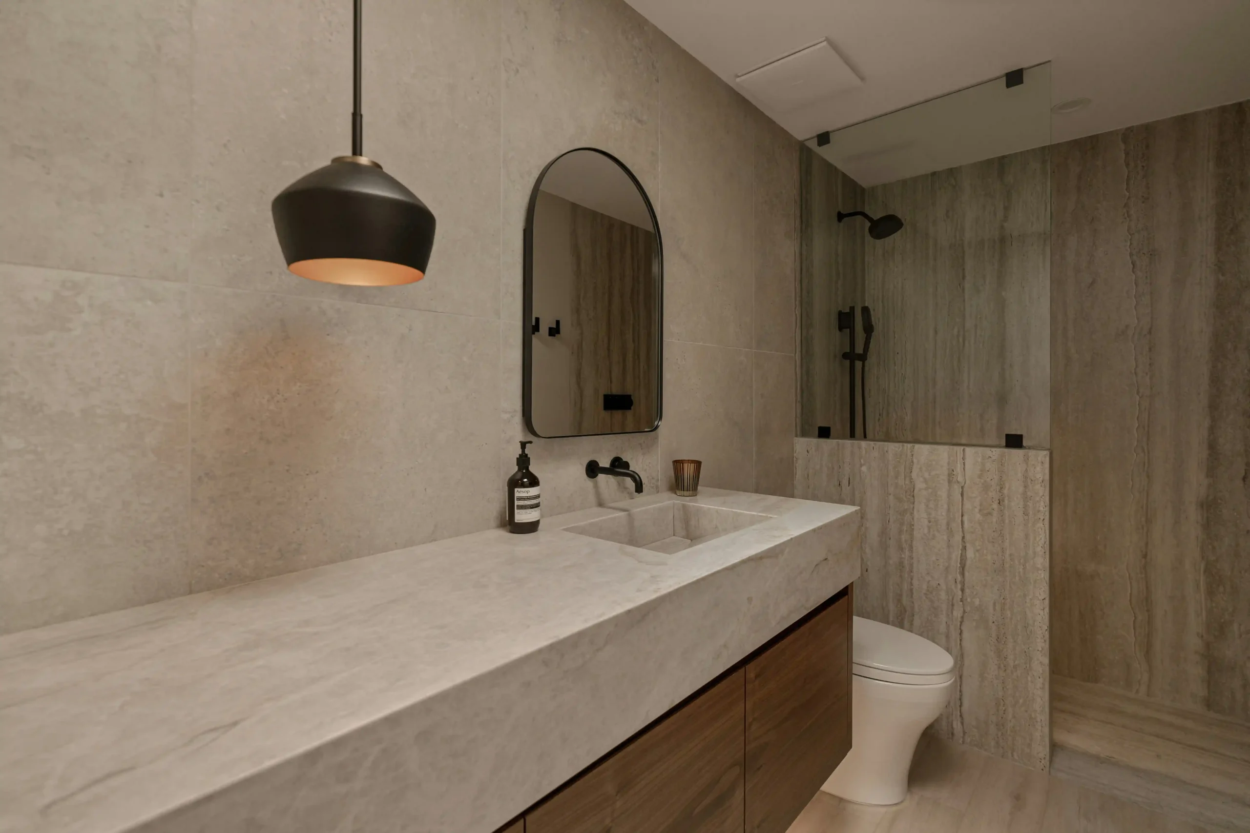 Modern bathroom renovation in Dubai with a long vanity and glass shower enclosure