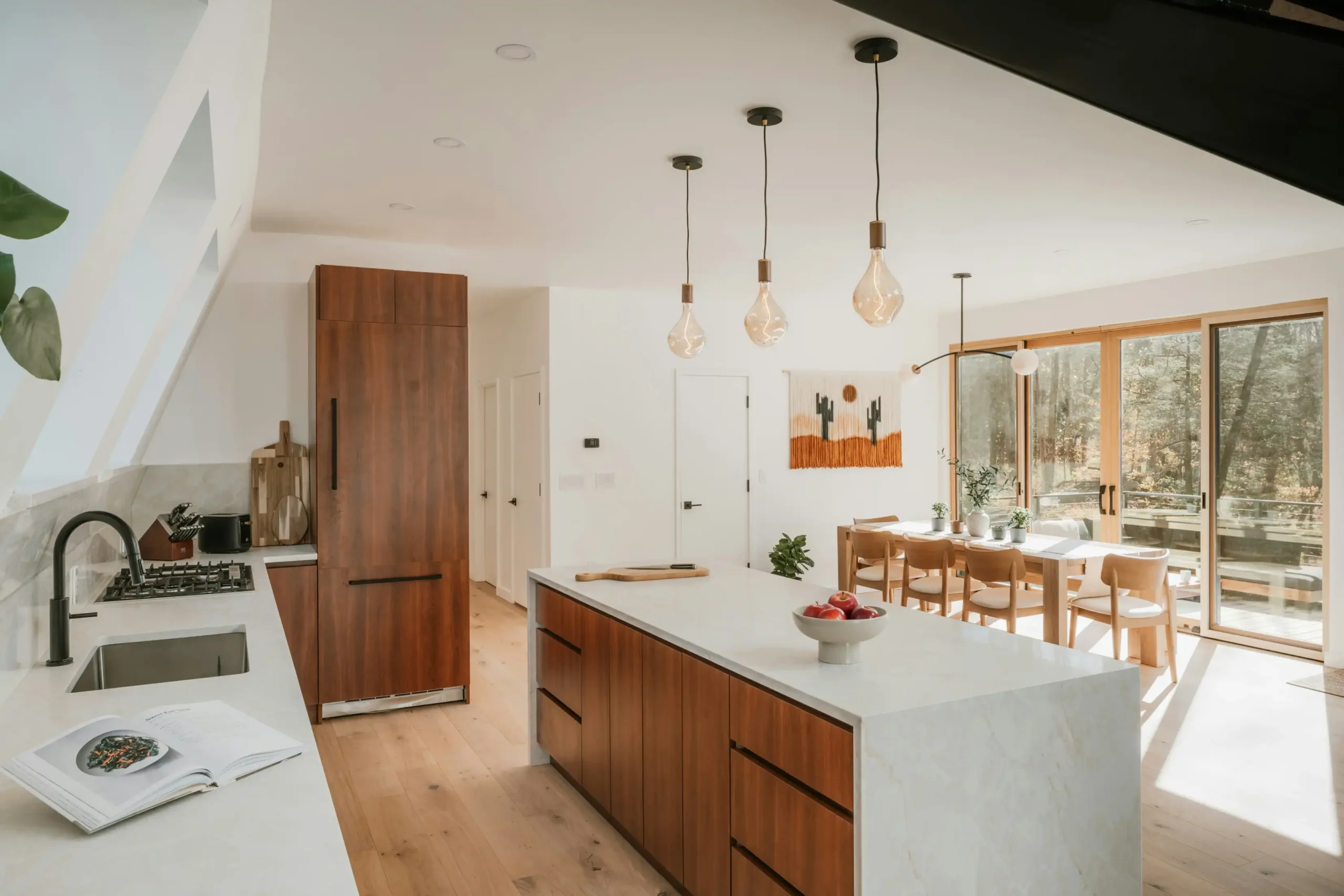Modern kitchen island renovation in Dubai with seating and a clean open-plan layout.