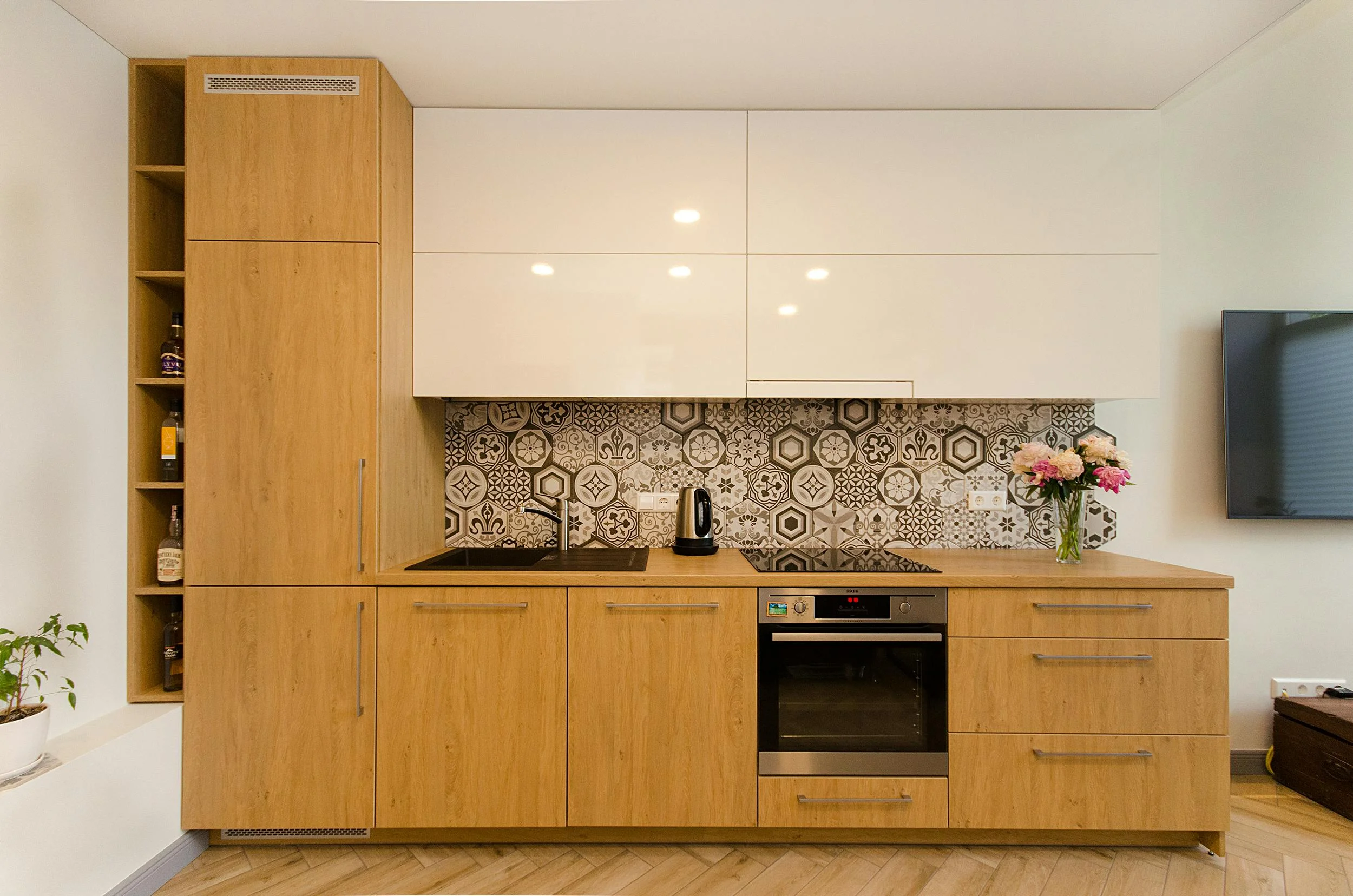 Kitchen upgrade in Dubai with refreshed cabinet doors, countertop, backsplash and lighting for a cleaner modern look.
