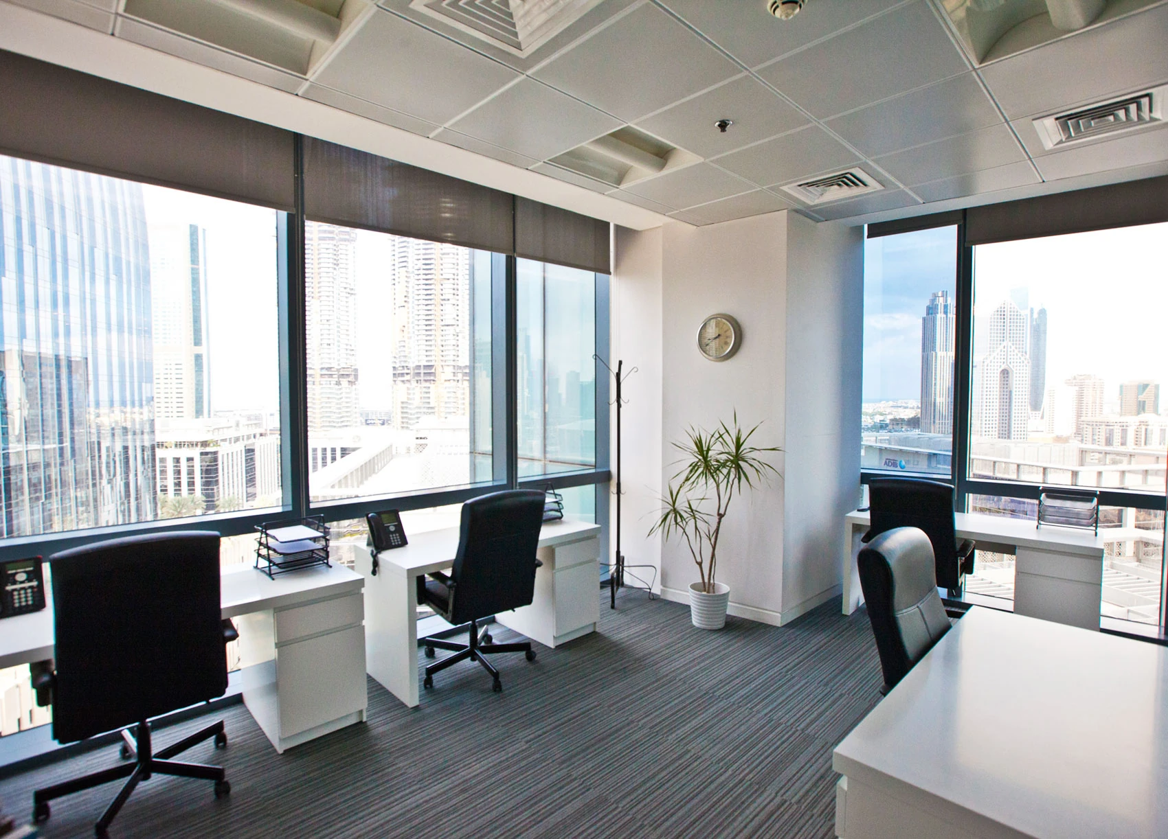 Commercial turnkey office fit-out in Dubai with modern workstations and skyline view