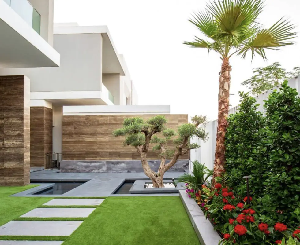 HB Interiors villa landscape construction in Dubai with turf, stepping stone pathway, and planting beds