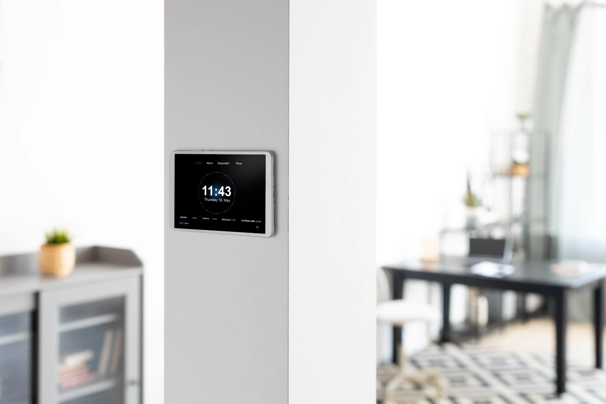 Wall-mounted smart home control tablet in a modern Dubai home interior