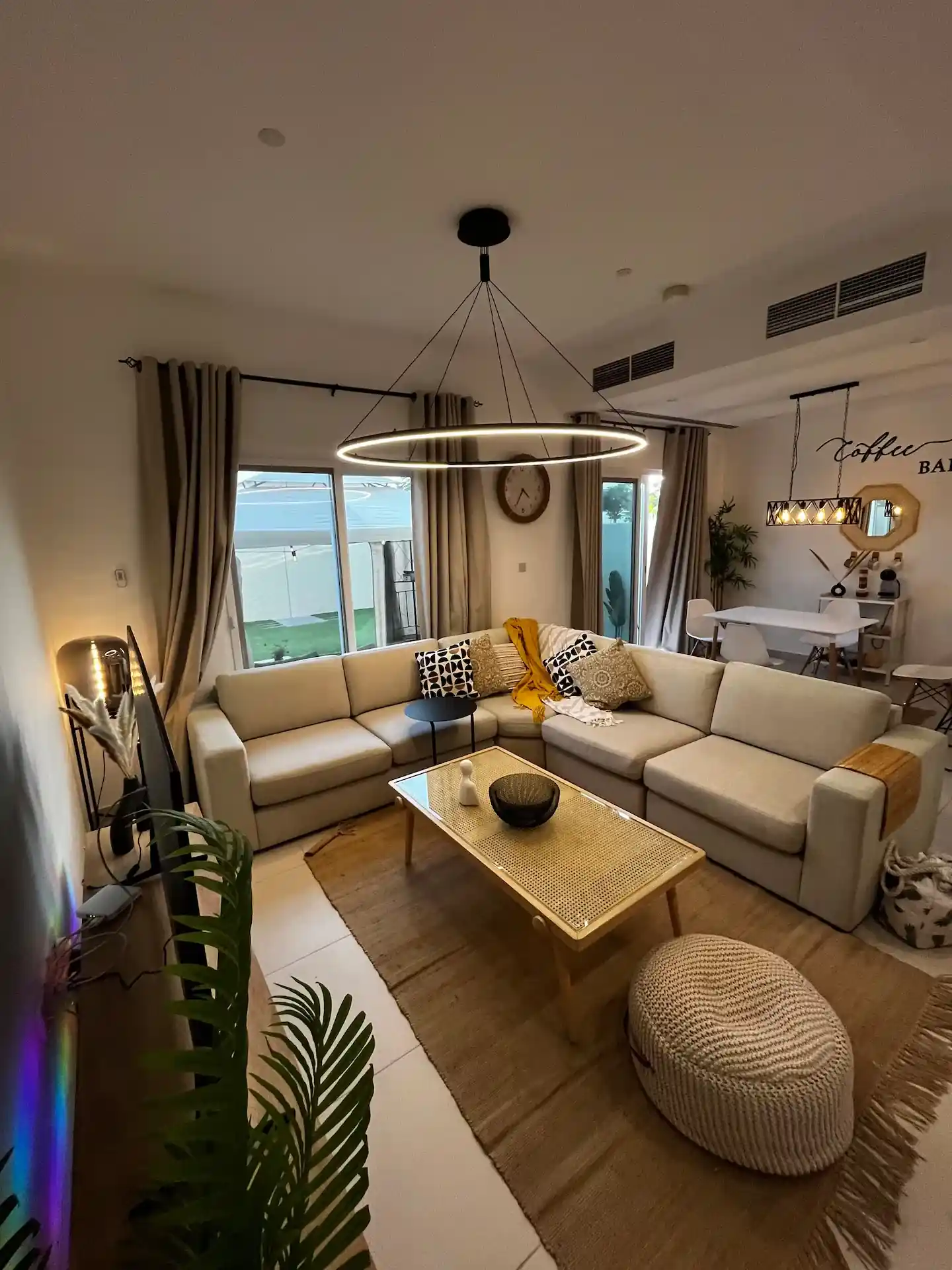 Turnkey interior fit-out in Dubai with styled living room, lighting, curtains, and dining area