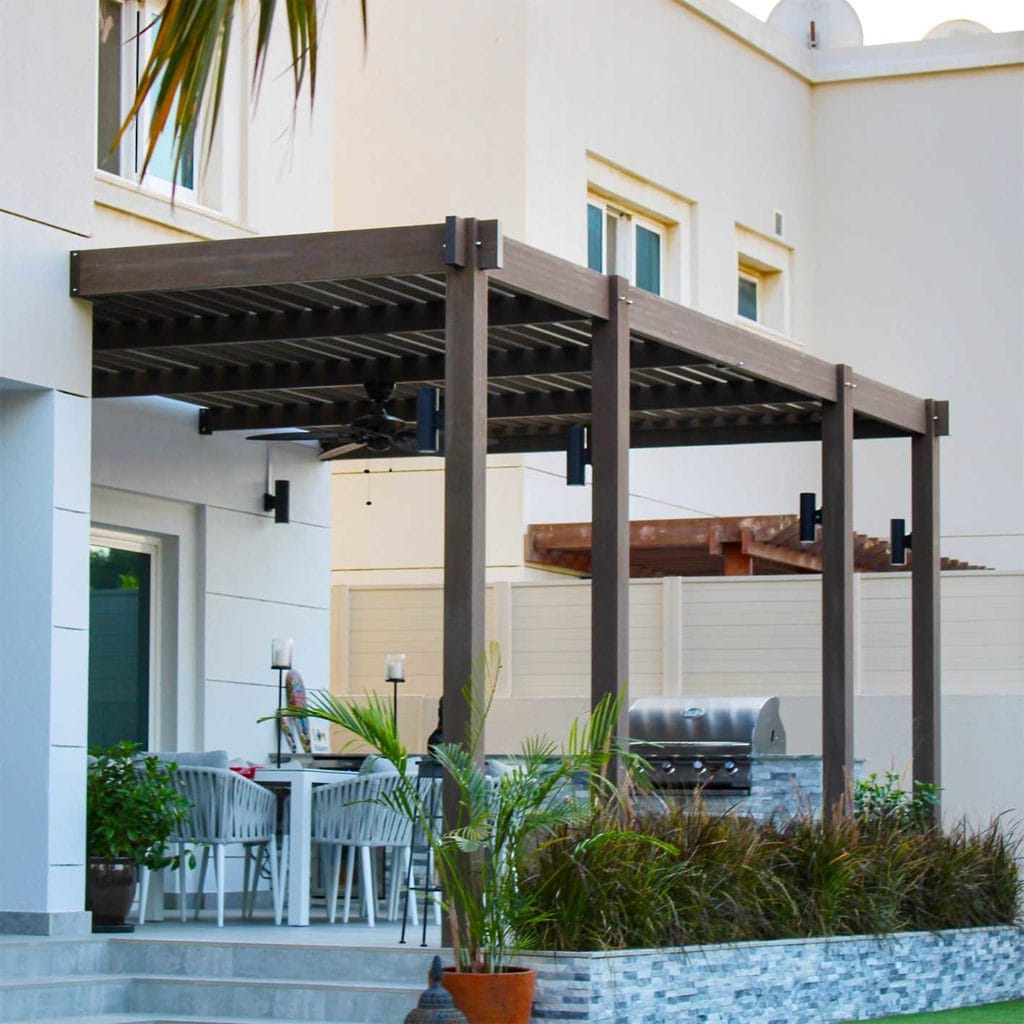 Treated timber pergola attached to a villa patio, shading an outdoor dining area