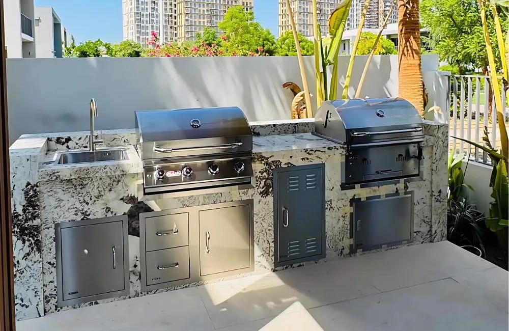 Outdoor kitchen and BBQ installation with built-in grill, prep counter, and storage in a Dubai villa by Homebase Interiors