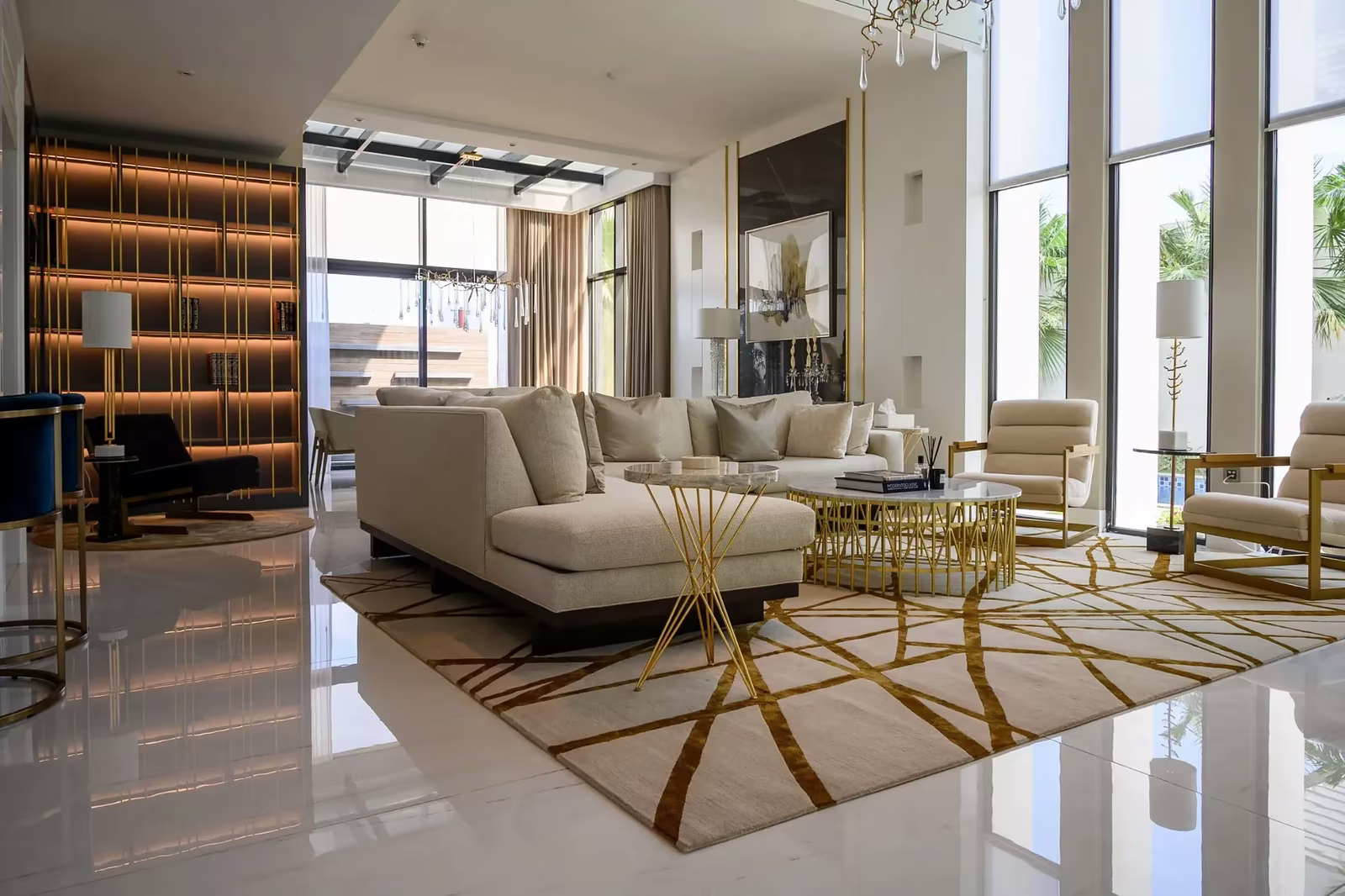 Home 1 Villa living room interior design in Dubai with warm neutral tones, sculptural furniture, and full-height windows